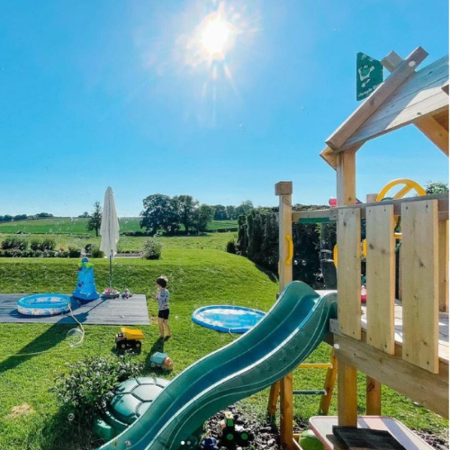 Jungle Gym climbing frame with slide in backyard Jungle Gym climbing frame with slide